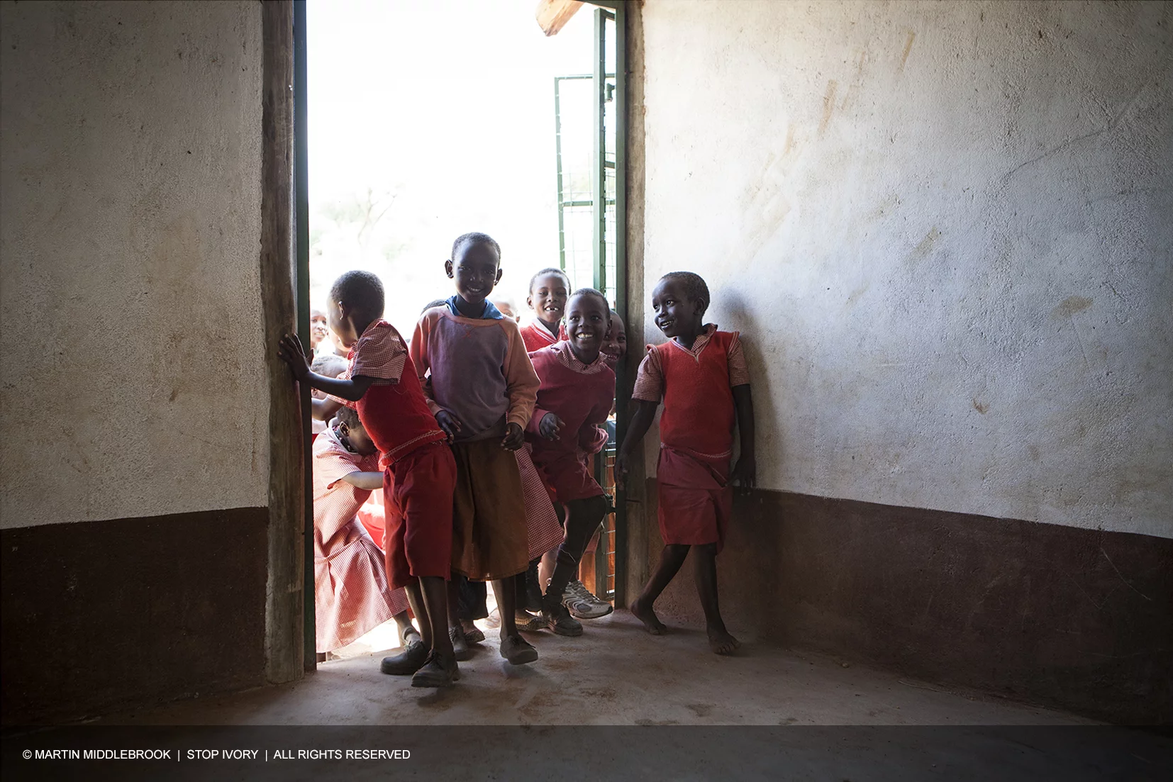 a group of children in a doorway